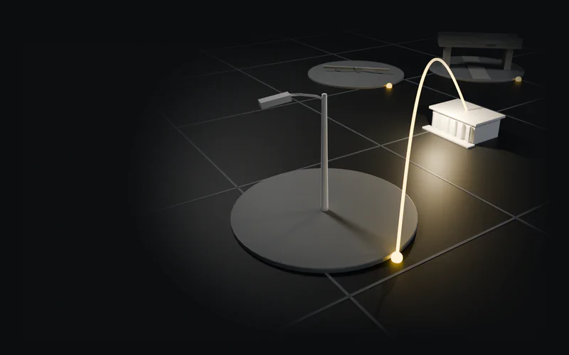 A white study model of an upright streetlight on a grey tile, with one amber arc to a white civic building; other tiles stand further back.